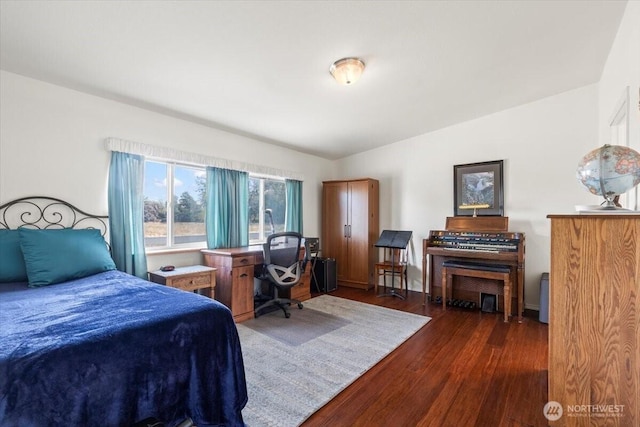 bedroom featuring dark wood-style floors and baseboards