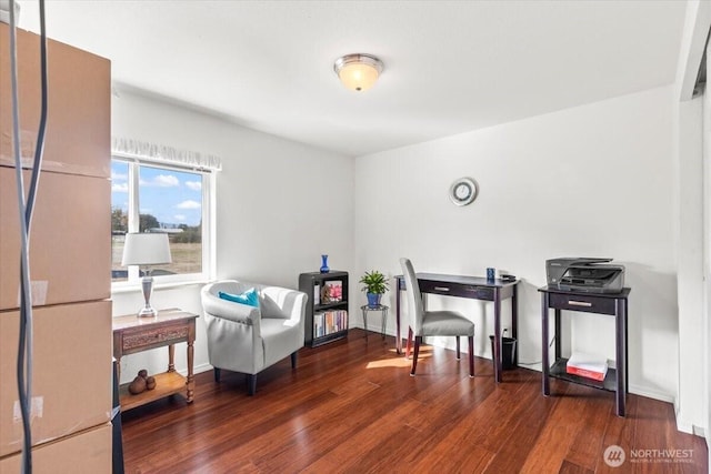 living area with wood finished floors and baseboards