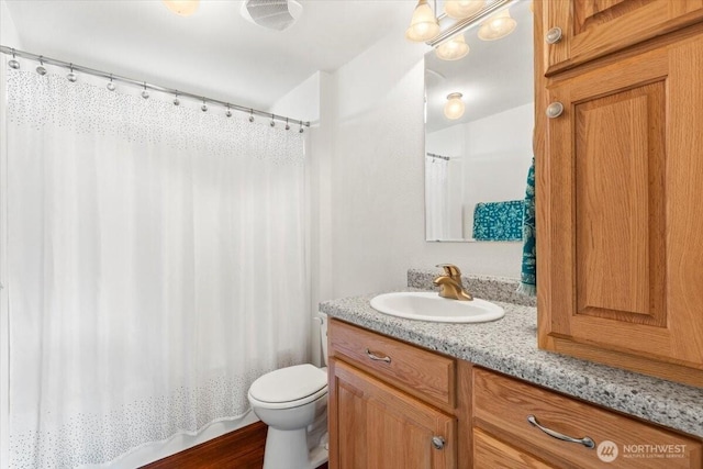 full bath featuring toilet and vanity