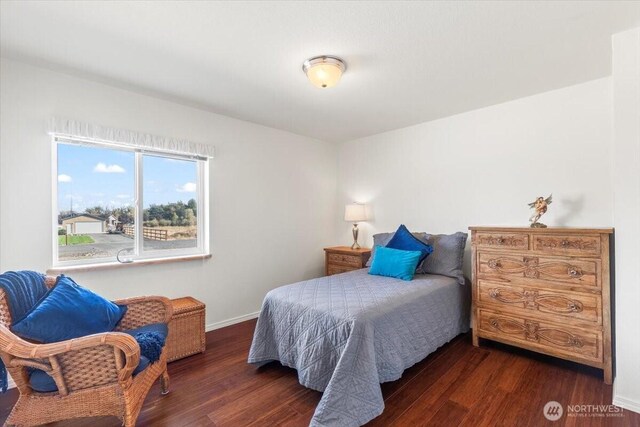 bedroom with baseboards and wood finished floors