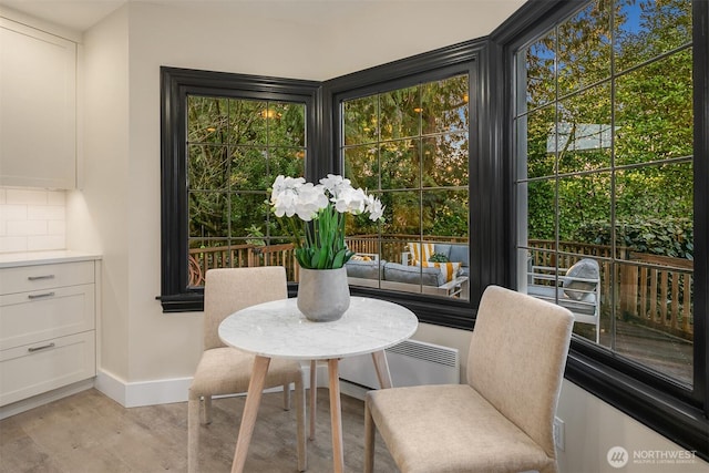 dining room with baseboards and light wood finished floors