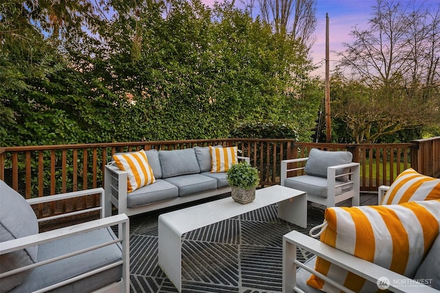 deck at dusk with an outdoor living space