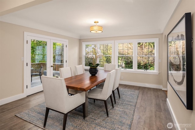 dining area featuring dark wood-type flooring, french doors, and baseboards