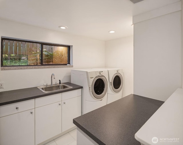 laundry area featuring a sink, cabinet space, recessed lighting, and washer and clothes dryer