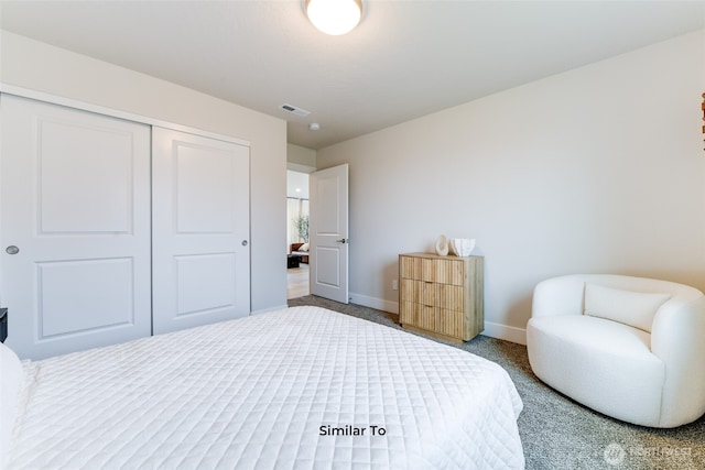 carpeted bedroom featuring baseboards, visible vents, and a closet