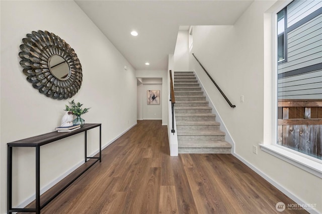 staircase featuring recessed lighting, wood finished floors, and baseboards