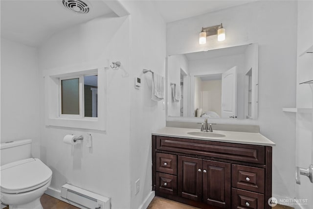 bathroom with toilet, baseboard heating, vanity, and visible vents