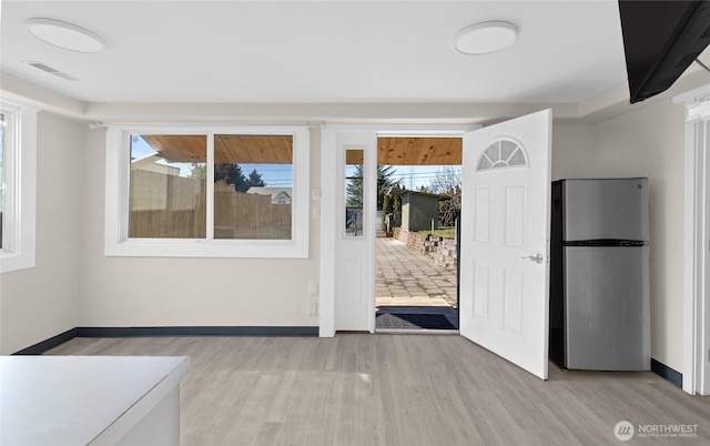 entryway featuring light wood-style floors, baseboards, and visible vents