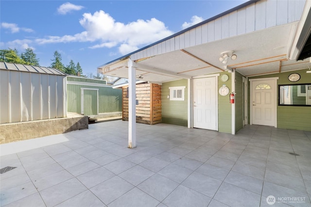 view of patio / terrace featuring an outbuilding and a shed