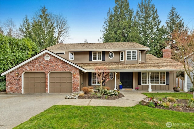 traditional-style home featuring a front lawn, board and batten siding, concrete driveway, an attached garage, and brick siding