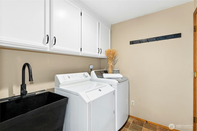 laundry area with washer and dryer, cabinet space, and a sink