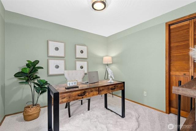 carpeted home office with baseboards