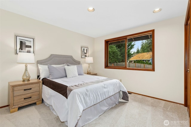 bedroom featuring recessed lighting, light colored carpet, and baseboards