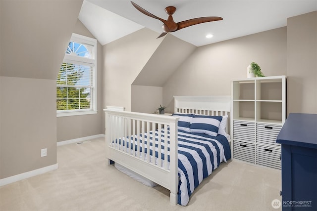 bedroom featuring light carpet, ceiling fan, vaulted ceiling, and baseboards