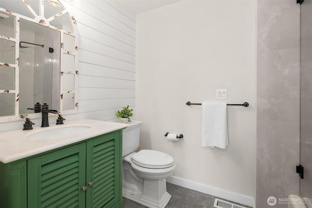 full bathroom with visible vents, toilet, vanity, baseboards, and tile patterned floors