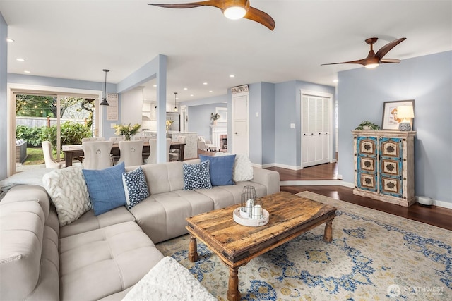 living area featuring ceiling fan, recessed lighting, wood finished floors, and baseboards