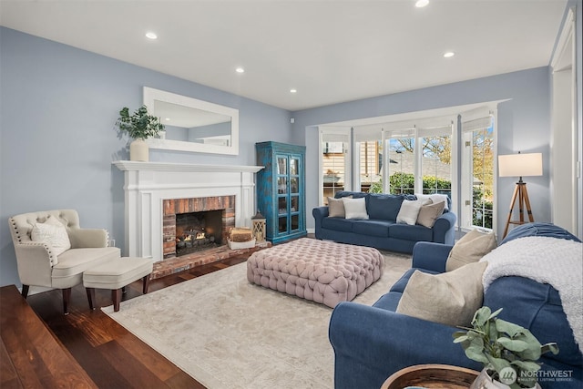 living area featuring a fireplace, wood finished floors, and recessed lighting