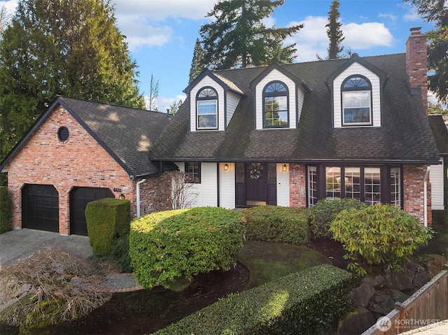 view of front facade with driveway, brick siding, roof with shingles, and an attached garage