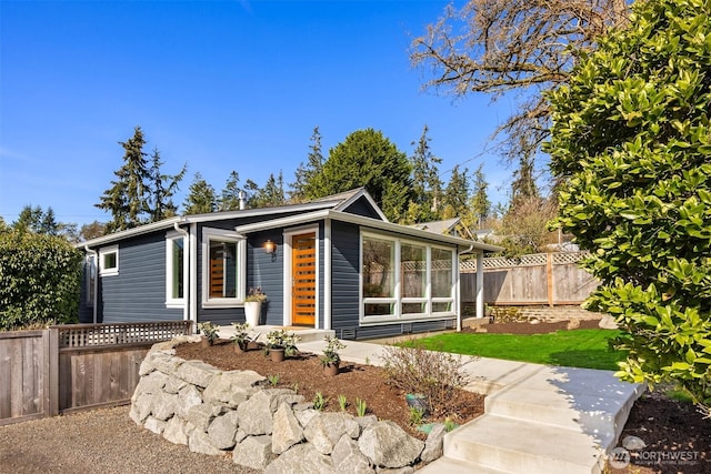 mid-century inspired home featuring fence