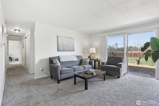 carpeted living room featuring baseboards