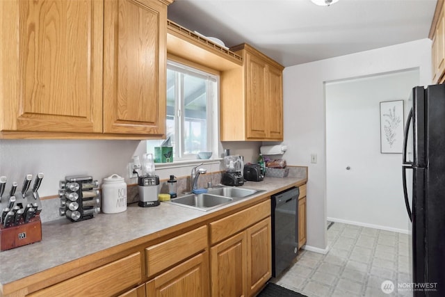 kitchen with black appliances, light floors, a sink, and light countertops