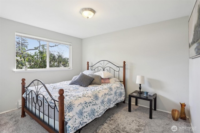 bedroom featuring carpet and baseboards