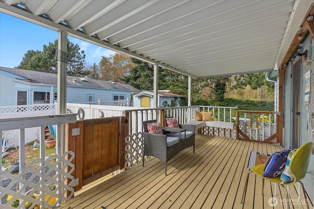 deck featuring an outdoor structure and a storage unit