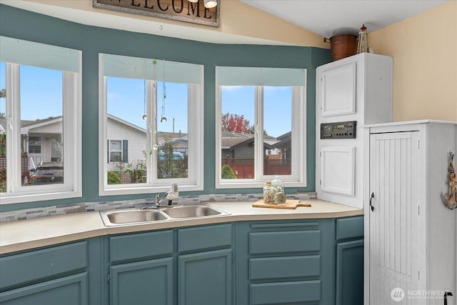 kitchen featuring light countertops, a sink, and a healthy amount of sunlight