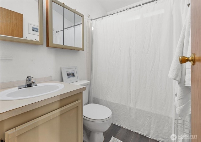 full bathroom featuring vanity, shower / bath combo with shower curtain, wood finished floors, and toilet