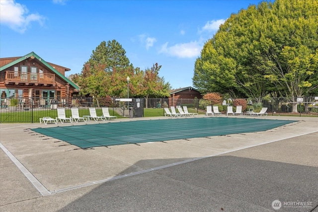 pool with fence and a patio