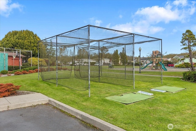 view of home's community featuring playground community and a yard