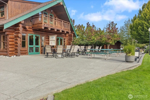 view of patio with french doors and a balcony