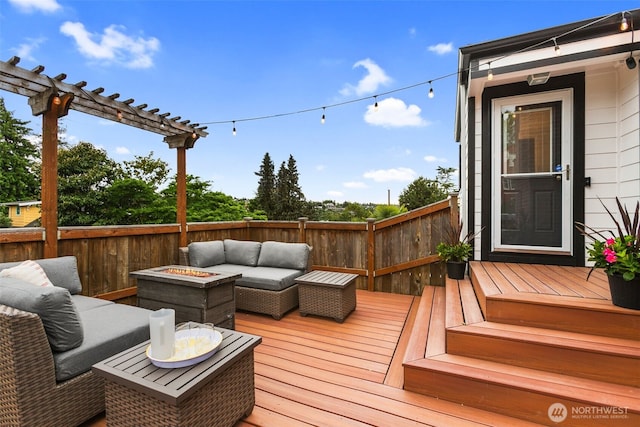 wooden terrace featuring an outdoor living space with a fire pit and a pergola