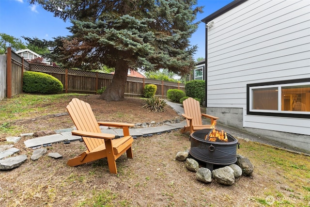 view of yard featuring a fenced backyard and an outdoor fire pit