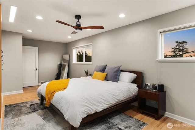 bedroom with recessed lighting, light wood-type flooring, and baseboards