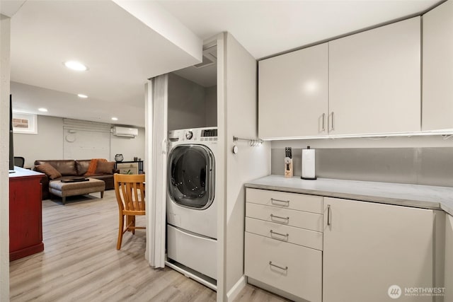 clothes washing area featuring laundry area, recessed lighting, washer / dryer, light wood-style floors, and a wall mounted AC