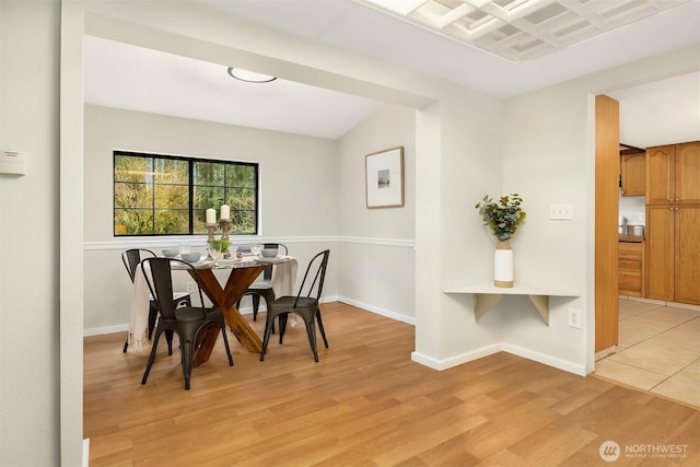 dining area featuring light wood-style floors and baseboards