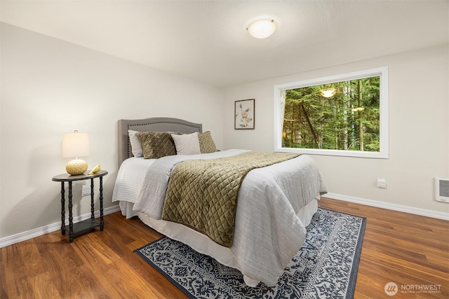 bedroom with baseboards and wood finished floors