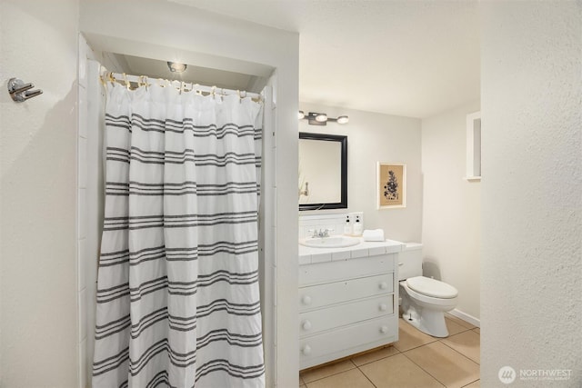 bathroom with toilet, tile patterned flooring, a shower with shower curtain, and vanity