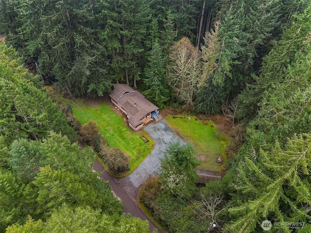 birds eye view of property featuring a view of trees