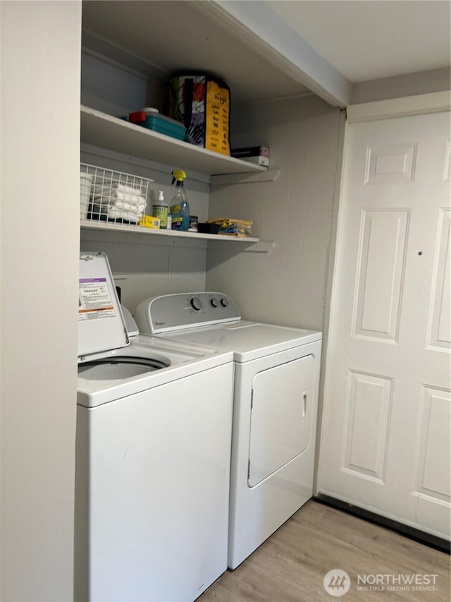 clothes washing area featuring laundry area, separate washer and dryer, and light wood-style floors