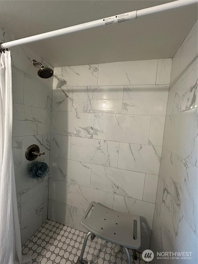 full bath with a tile shower