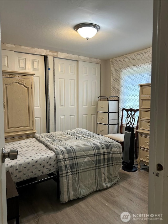 bedroom with a closet and wood finished floors