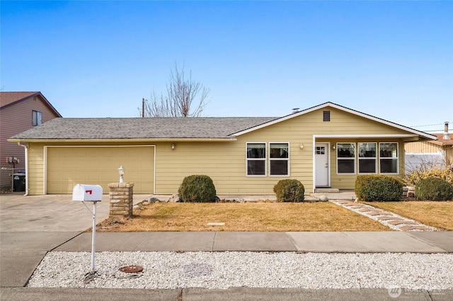 view of front of house featuring a shingled roof, driveway, and an attached garage