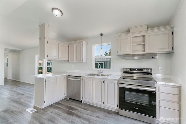 kitchen with visible vents, a sink, stainless steel appliances, light countertops, and under cabinet range hood