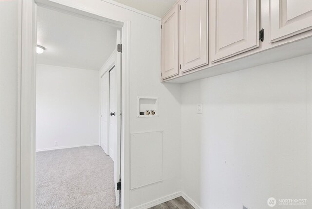 clothes washing area featuring cabinet space, hookup for a washing machine, baseboards, and carpet