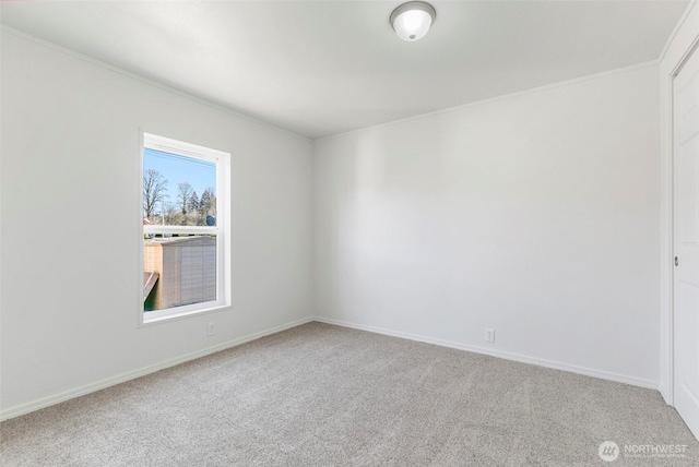 unfurnished room with baseboards, carpet, and crown molding