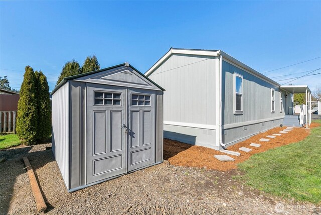 view of shed featuring fence