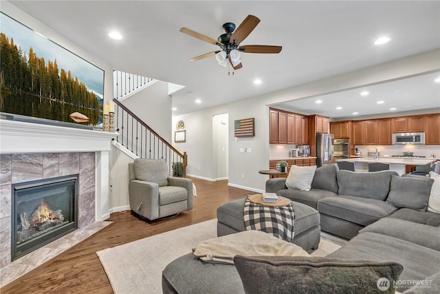 living area featuring stairs, recessed lighting, and wood finished floors