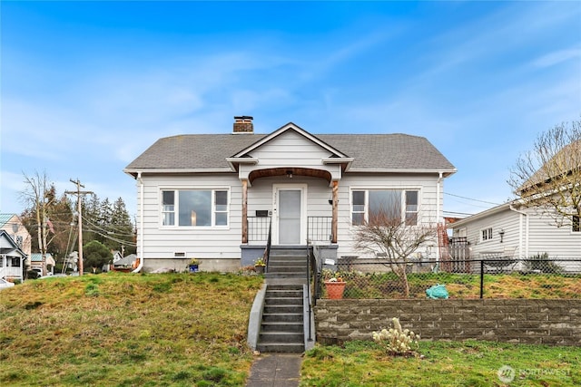 bungalow featuring a shingled roof, a chimney, and fence